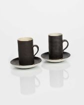 Φ Dame Lucie Rie DBE (1902-1995) a pair of stoneware coffee cups and saucers, cylindrical with