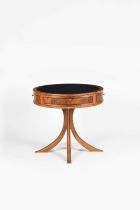 An English Walnut drum table by James Winby, circular, on four curved legs forming central pedestal,