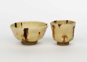 Takeshi Yasuda (born 1943) a stoneware footed bowl, covered in manganese and cream glaze with slip