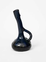 A Sunflower Pottery ewer by Sir Edmund Elton, ovoid with tall angled neck and double looped
