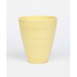 A Wedgwood Pottery vase designed by Keith Murray, flaring bucket form, covered in a yellow Matt