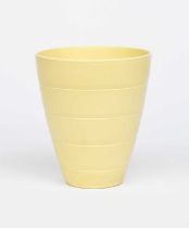 A Wedgwood Pottery vase designed by Keith Murray, flaring bucket form, covered in a yellow Matt