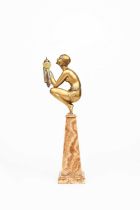 Φ Georges Duvernet (1870-1955) Oblivion, a patinated bronze model of a crouching lady offering up an