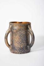 A Sunflower Pottery tyg by Sir Edmund Elton, swollen, cylindrical form, the handles with mask