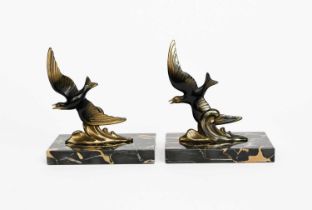 A pair of Art Deco patinated metal book ends by Tedd, each modelled as a seagull flying above