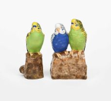 A Royal Copenhagen faience model of two budgerigars designed by Jeanne Grut, model no.3280, perched,