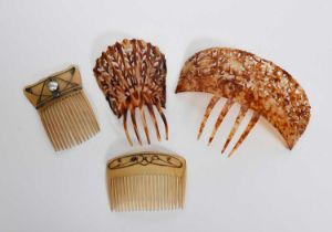 An Art Nouveau hair comb, set with pierced and cast white metal Jugendstil panel with abalone