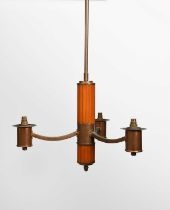 An Art Deco bakelite and copper three light electric ceiling light, the tapering, fluted bakelite