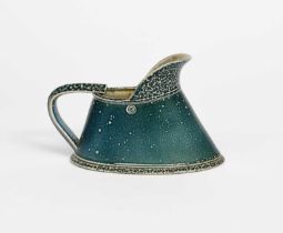 Φ Walter Keeler (born 1942) a salt-glaze stoneware jug, glazed blue, impressed seal mark, 19cm. wide