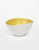 Φ Dame Lucie Rie DBE (1902-1995) a stoneware pouring bowl, elliptical, the interior glazed yellow,