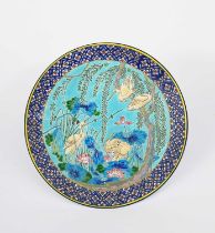 A Longwy Pottery plate, shape no.1283, decorated with cranes amidst water-lily flowers, in colours