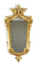 AN ITALIAN GILTWOOD WALL MIRROR FLORENTINE, 19TH CENTURY of tapering form, the later plate within