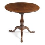 A GEORGE III MAHOGANY TRIPOD TABLE C.1760 the circular tilt top revolving on a birdcage above a