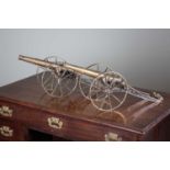 A PAIR OF VICTORIAN BRASS MODEL DESK CANNON MID-19TH CENTURY each with a turned barrel on a