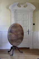 A GEORGE II MAHOGANY TRIPOD TABLE CHIPPENDALE PERIOD, C.1750 the circular tilt-top on a turned gun