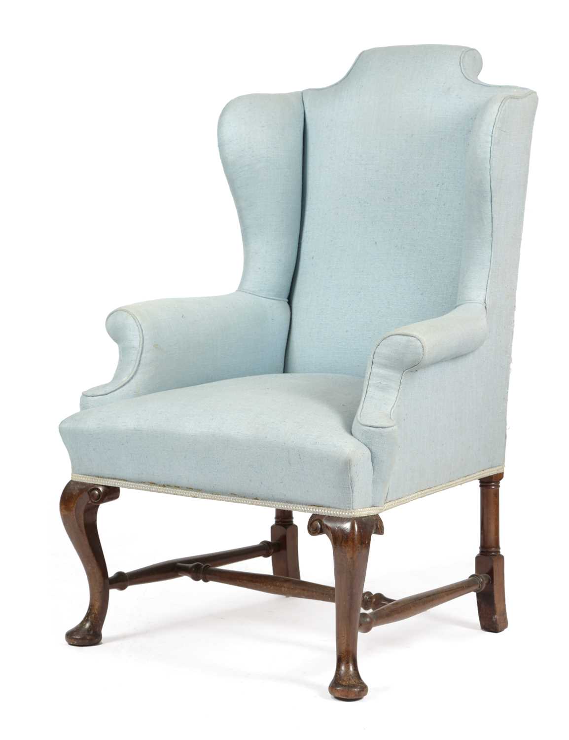 A WALNUT WING ARMCHAIR IN GEORGE II STYLE, LATE 19TH CENTURY on cabriole front legs united by turned