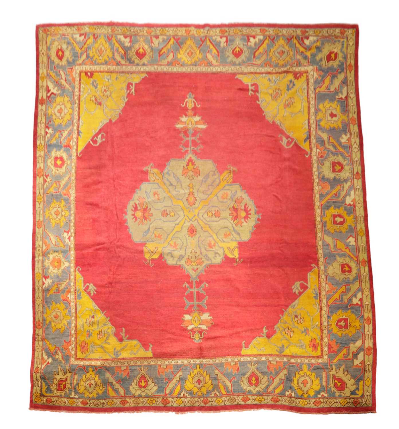 AN USHAK CARPET OF UNUSUAL SIZE CENTRAL WEST ANATOLIA, C.1900 the plain raspberry field centered