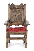 AN OAK ARMCHAIR 17TH CENTURY ELEMENTS the moulded crest decorated with flowers and leaves, above a