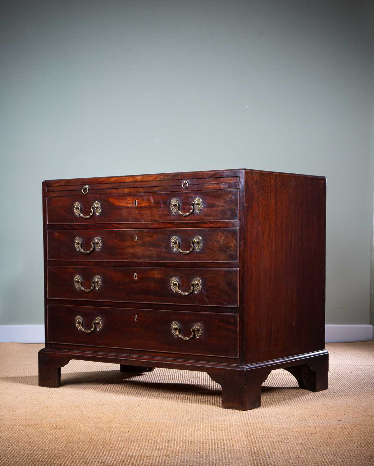 AN EARLY GEORGE III MAHOGANY CHEST C.1760 the caddy moulded top above a brushing slide and four