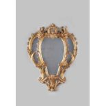 AN EARLY GEORGE III GILTWOOD MIRROR C.1760 with composite plates within a finely carved leaf and