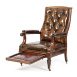 A GEORGE IV MAHOGANY LIBRARY ARMCHAIR C.1830 covered with brass studded leather and with a pull-