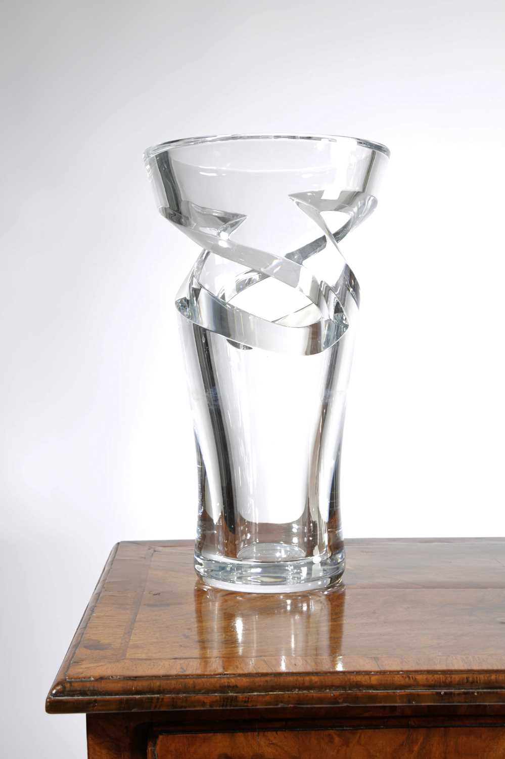 A BACCARAT GLASS TORNADO VASE 20TH CENTURY of flaring cylindrical form with cut-out twisting