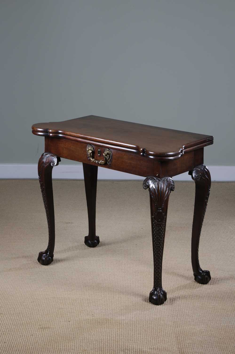 A FINE GEORGE II MAHOGANY CONCERTINA CARD TABLE C.1740-50 the fold-over top revealing a baize