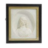 A REGENCY WAX PORTRAIT OF A YOUNG LADY EARLY 19TH CENTURY in an oval recess, with a gilt slip and