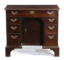 A GEORGE II MAHOGANY KNEEHOLE DESK C.1750-60 the caddy moulded edge top with re-entrant front