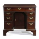 A GEORGE II MAHOGANY KNEEHOLE DESK C.1750-60 the caddy moulded edge top with re-entrant front