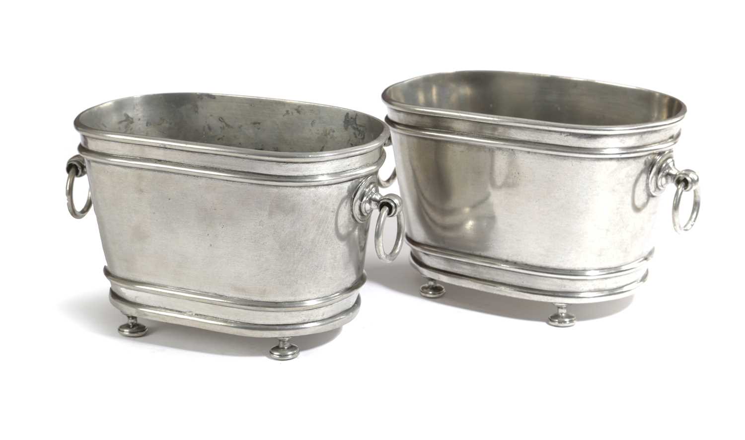 A PAIR OF FRENCH POLISHED STEEL JARDINIERES OR WINE COOLERS EARLY 20TH CENTURY of oval form with