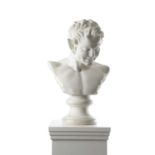 AN ITALIAN WHITE MARBLE GRAND TOUR BUST OF A FAUN 19TH CENTURY with a grinning face, on a turned