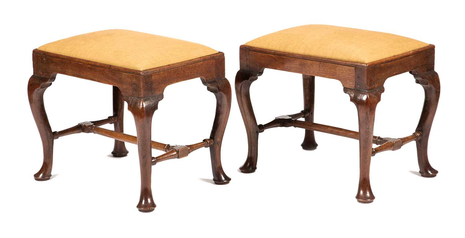 A PAIR OF GEORGE II VIRGINIAN WALNUT STOOLS C.1730 each with a drop-in seat on cabriole legs and pad