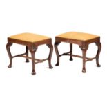 A PAIR OF GEORGE II VIRGINIAN WALNUT STOOLS C.1730 each with a drop-in seat on cabriole legs and pad