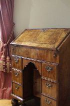 A QUEEN ANNE WALNUT KNEEHOLE BUREAU C.1710 the fall front with feather banding and enclosing a