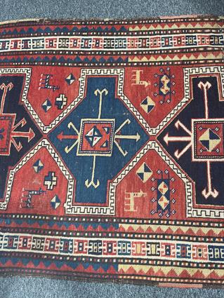 A KAZAK RUG CENTRAL CAUCASUS, C.1890 the madder field with four linked panels of hooked motifs - Image 4 of 5