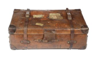 A LARGE BROWN LEATHER TRUNK LATE 19TH / EARLY 20TH CENTURY the studded lid with applied travel
