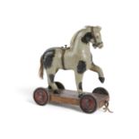 A PAINTED WOOD TOY PULL-ALONG HORSE EARLY 20TH CENTURY grey with black patches, on a four wheeled