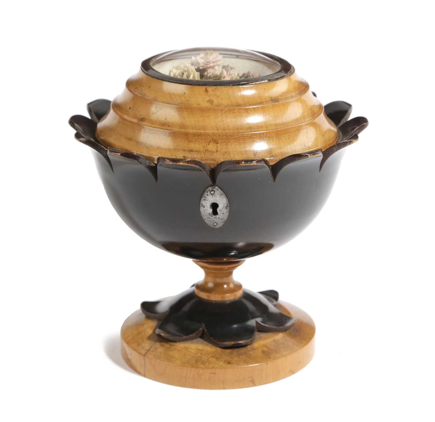 A FRENCH FRUITWOOD AND EBONISED TEA CADDY EARLY 19TH CENTURY of flowerhead form, the cover with a