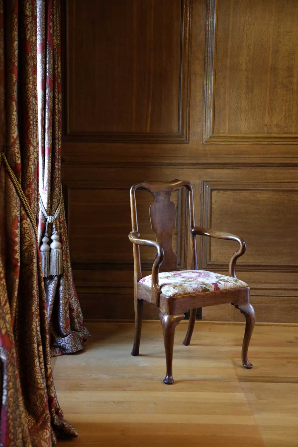 A QUEEN ANNE WALNUT ARMCHAIR C.1710 the shaped rectangular back with a vase splat above scrolling