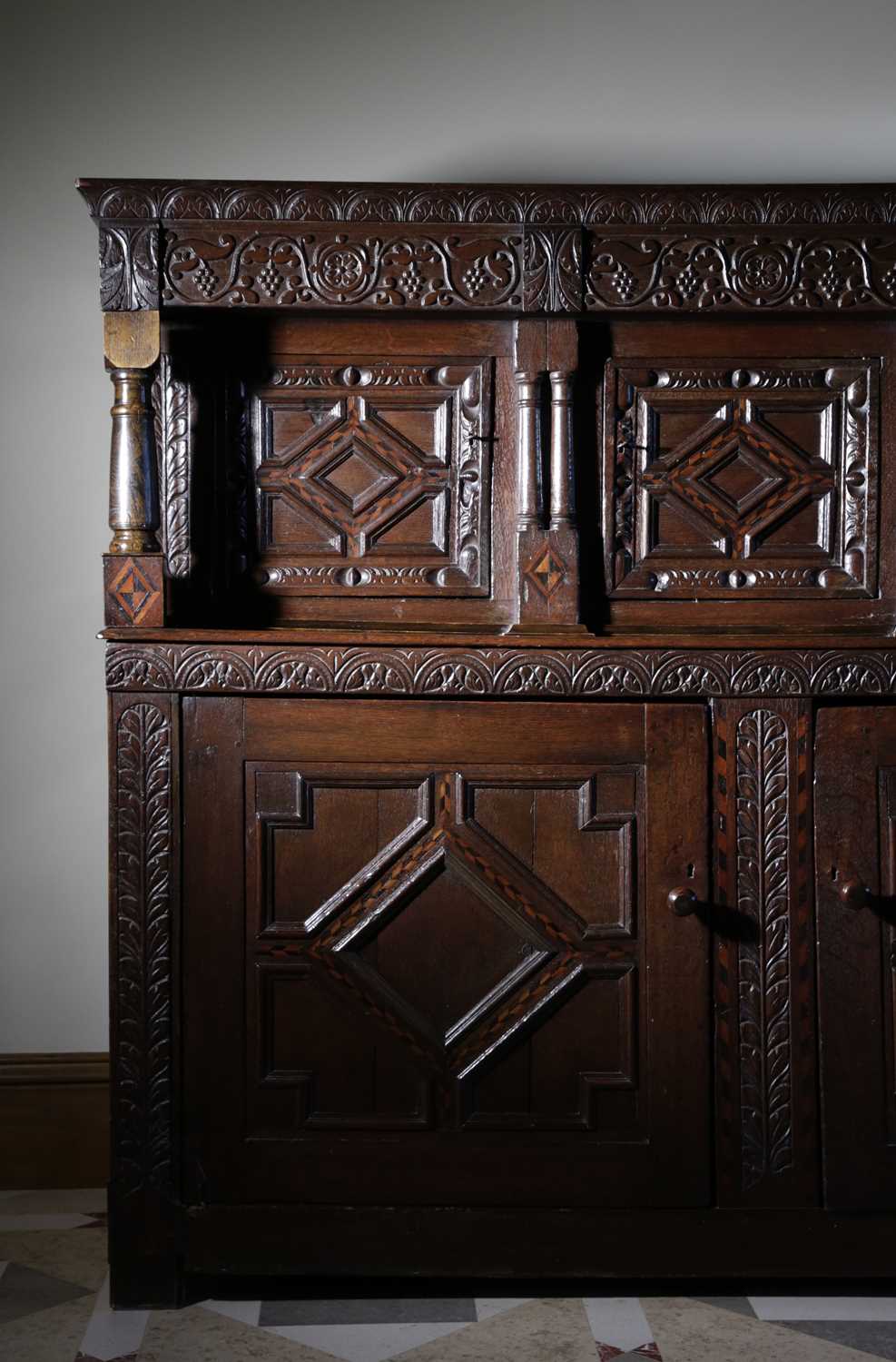 AN OAK COURT CUPBOARD LEEDS, YORKSHIRE, 17TH CENTURY AND LATER the frieze with scrolling fruiting - Image 2 of 2