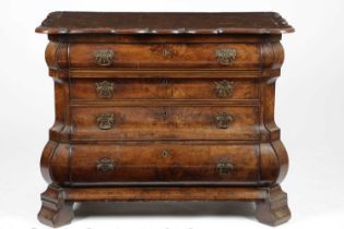 A DUTCH WALNUT BOMBÉ COMMODE LATE 18TH / EARLY 19TH CENTURY the quarter veneered top with a shaped