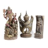 THREE EASTERN CARVINGS to include: a polychrome painted figure of Lakshmi sat on a pile of fruits, a