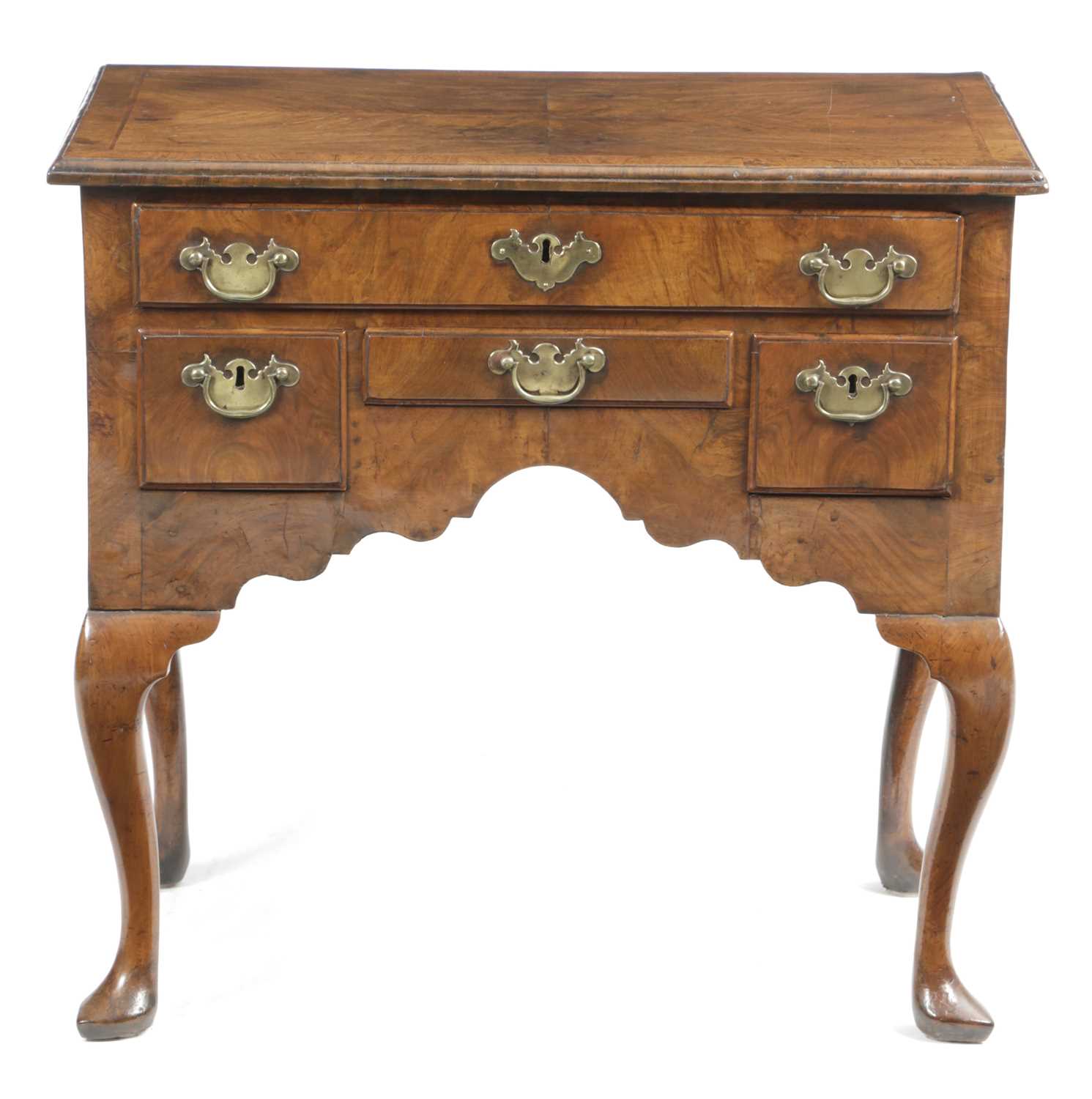 A QUEEN ANNE WALNUT LOWBOY C.1710 cross and feather banded, the quarter veneered top above one