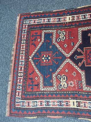 A KAZAK RUG CENTRAL CAUCASUS, C.1890 the madder field with four linked panels of hooked motifs - Image 2 of 5