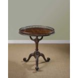 A FINE GEORGE II MAHOGANY TRIPOD TABLE C.1755 the circular top with baluster gallery, on a central