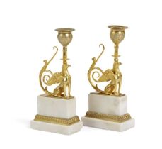 A PAIR OF GEORGE III ORMOLU AND WHITE MARBLE CANDLESTICKS AFTER SIR WILLIAM CHAMBERS, C.1790-1800