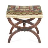 AN EARLY VICTORIAN MAHOGANY 'X' FRAME STOOL C.1850 with a needlework seat on panelled legs united by