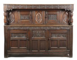 A CHARLES II OAK COURT CUPBOARD PROBABLY WEST COUNTRY, DATED '1676' the carved frieze above a pair