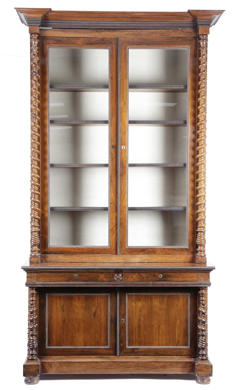 λ A CONTINENTAL ROSEWOOD BOOKCASE MID-19TH CENTURY the inverted breakfront cornice above a pair of